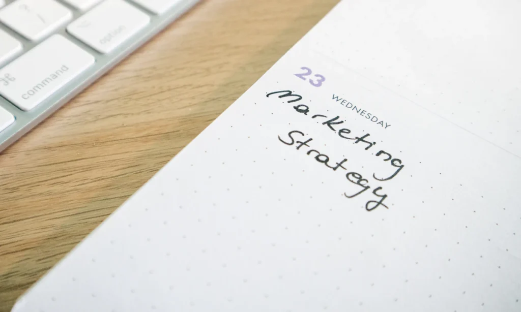 Agenda con la frase Marketing Strategy sobre un escritorio